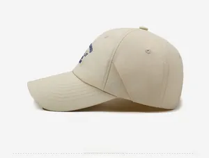 Detail of light beige baseball cap with blue letter embroidery and fine stitching