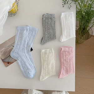 Five pairs of breathable lace mesh socks for women in pastel colors on a white surface