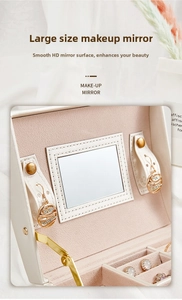 Detail of jewelry box with large makeup mirror, pink velvet lining and earring storage