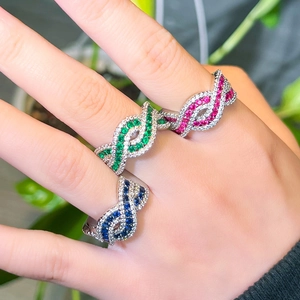 Detail of interlocking silver rings with pave-set ruby, emerald, and sapphire zircons