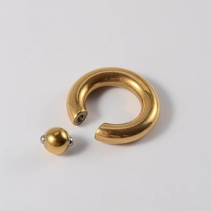 Detailed close-up of golden stainless steel captive bead ring on a clean white background