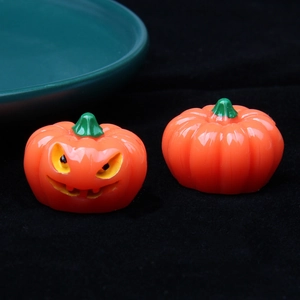 Close-up of resin Halloween pumpkin ornaments with a detailed jack-o'-lantern face detail