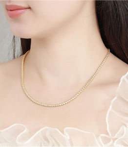 Close-up of elegant 2mm Moissanite bubble tennis necklace on a female neck