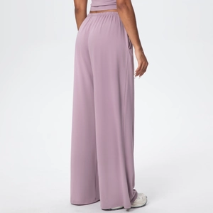 Detail view of purple high-waist wide-leg athletic pants with hidden side pocket