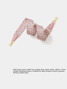 Close-up of pink leopard print woven bag strap with golden metal swivel hooks