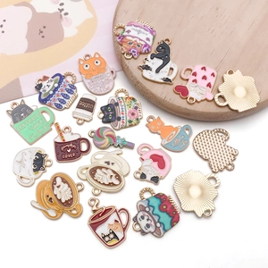 Macro view of colorful enamel cat and coffee cup charms for DIY jewelry making