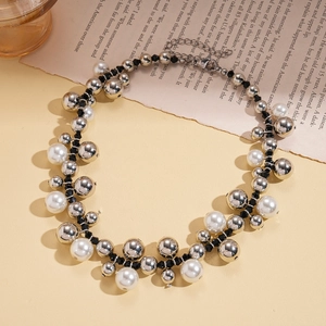 Retro beaded sweater chain with imitation pearls and silver metal beads on a vintage page