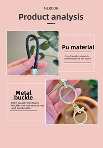 Detail view of woven black PU leather key ring with durable gold metal clasp buckle