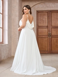 Detailed back view of white lace wedding dress with backless design and tied straps