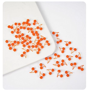Macro detail of miniature resin cherries for DIY crafts and cake decorations