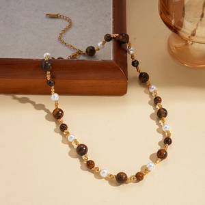 Detail view of 18K gold plated beaded necklace with brown stones and white pearls