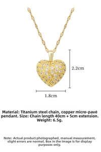 Macro shot of gold broken heart pendant with zircon pavé and titanium steel chain