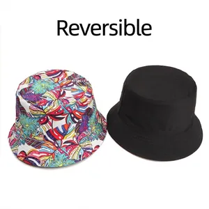 Double-sided reversible bucket hat with tropical leaf print and solid black canvas design