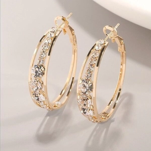 Macro shot of gold-plated hoop earrings with three-row pavé setting of cubic zirconia