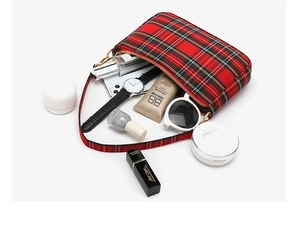Detail view of red tartan baguette bag showing spacious interior with daily essentials