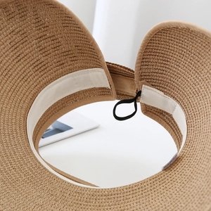 Detail of the internal sweatband and elastic strap of the leopard print straw sun hat