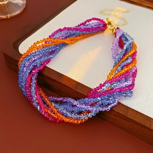 Macro detail of multi-layered bohemian beaded necklace with colorful faceted crystals