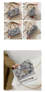 Detail view of snakeskin textured square bag with gold chain strap and interlocking buckle