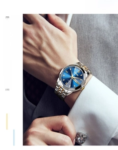 Close-up of luxury men's quartz watch with blue sunray dial and two-tone steel band