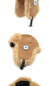 Detail of brown trapper hat featuring faux suede fabric and thick plush lining for winter sports