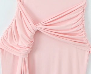 Détail du drapé élégant et du ruban latéral sur une robe longue rose sans manches