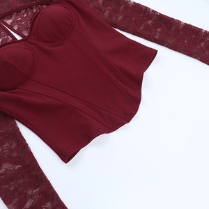 Detail of dark red lace patchwork on a slim-fit corset long-sleeve top with floral patterns