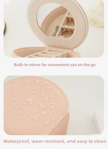 Detail of pink PU leather jewelry box showing interior makeup mirror and waterproof surface