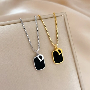Minimalist titanium steel necklaces in gold and silver with black D-letter pendant