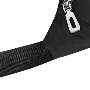 Detail of silver metal zipper and reinforced strap on black waterproof nylon waist bag