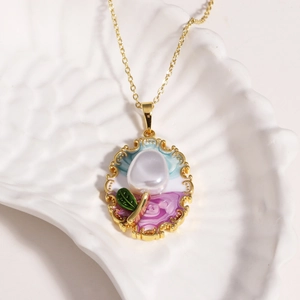 Detail of vintage enamel floral pendant with natural pearl on gold choker chain