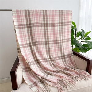 Close-up of pink and khaki plaid cashmere-like scarf with soft tassels on a chair