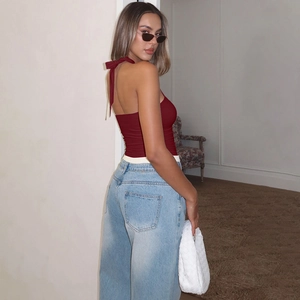 Close-up of burgundy halter top back showing elegant bow tie-up and backless design