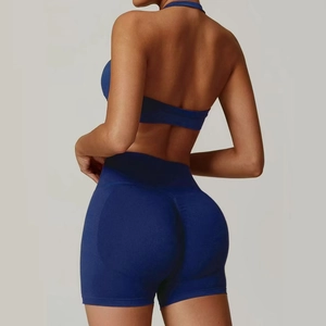 Women's dark blue halter yoga set featuring high-waisted shorts and seamless ribbed fabric
