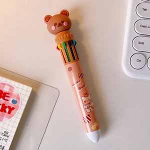 Detail of cute pink multi-color ballpoint pen with brown bear topper and Happy Bear print