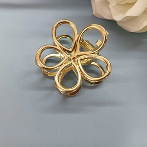 Minimalist gold plum blossom metal hair claw clip for women featuring hollow floral design