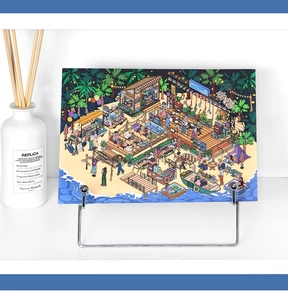 Artistic isometric beach scene sticker displayed on a silver stand in a minimal setting