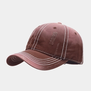 Detail of vintage washed cotton baseball cap with white contrast stitching and distressed brim