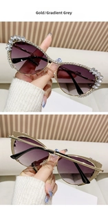 Detailed close-up of crystal-encrusted gold cat-eye sunglasses with gradient grey lenses