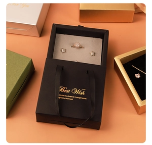 Detail of premium drawer jewelry gift boxes with gold foil print and velvet ring inserts