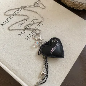Black leather heart pendant necklace with silver bow detail and colorful beads