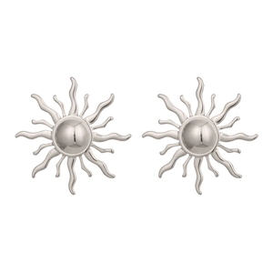 Macro detail of silver sun stud earrings with radiant ray design and polished finish