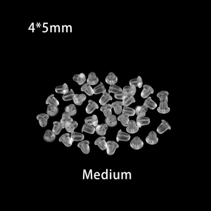 Macro view of 4x5mm medium transparent silicone earring backs on a black background