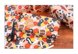 Detail of vintage kraft wrapping paper featuring soccer, basketball, and football patterns