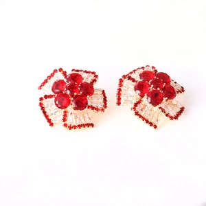 Luxury floral stud earrings with red crystal and cubic zirconia in golden setting