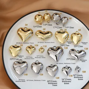Macro view of assorted gold and silver resin heart and ball pendants on a ceramic tray