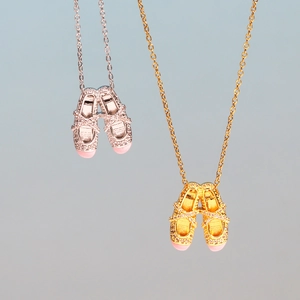 Elegant gold and silver ballet slipper necklaces with pink enamel and zircon accents