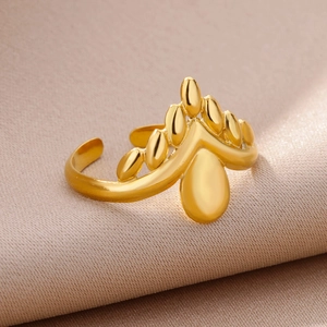 Detail of 18k gold plated stainless steel adjustable ring with leaf and crown motifs