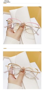 Detail of metal cat-eye glasses frame with pink trim and gold finish for women