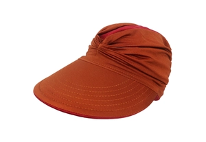 Detail view of brick red sun visor with pleated texture and wide brim for UV protection