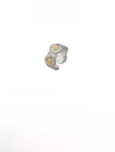 Macro shot of silver daisy ring featuring golden center detail and 11mm wide band